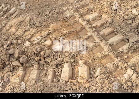 Background of dry mud volcanoes with path of lava.Tire tracks. Agriculture, cultivation. Stock Photo