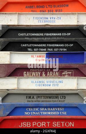 Various plastic fish boxes for use by commercial fishermen. Stock Photo
