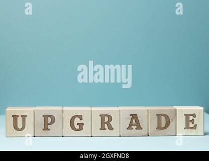 inscription upgrade on wooden cubes. Updating and upgrading, improving programs and products. Updated version, blue background Stock Photo