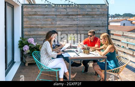 People working on the terrace of the office Stock Photo