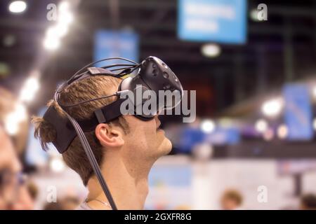 Young man is using virtual reality glasses on an expo Stock Photo
