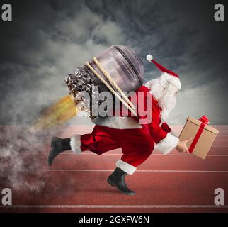 Santa Claus with gift box runs with a missile in a track Stock Photo