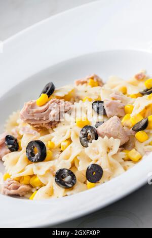 Pasta Farfalle With Tuna, Black Olives And Corn Stock Photo - Alamy