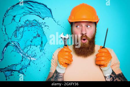 Incompetent worker plumber is unsure about his work Stock Photo