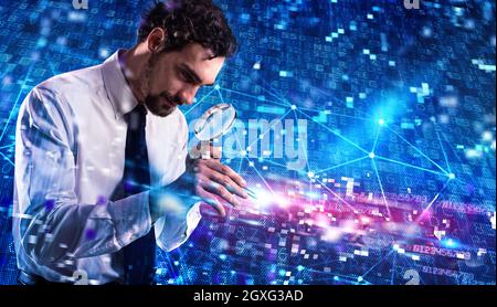 Businessman analyzes a computer system for virus and hacker attacks with lens Stock Photo