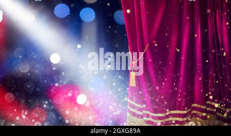 The red curtains of the stage are opening for the theater show Stock Photo