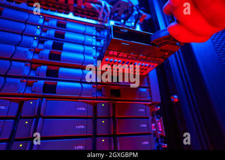 It engineer is disassembling and repairing computer server in data center Stock Photo