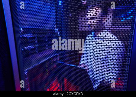 Professional it specialist examining work of supercomputer in data center Stock Photo