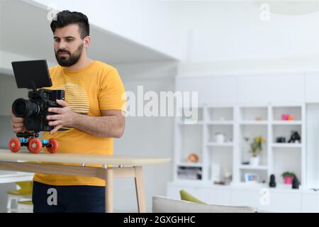 a cameraman with professional equipment shoots video clips in the studio. Stock Photo