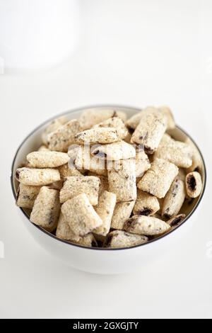Dry breakfast cereal pads with milk on a light table. selective focus. The concept of healthy, dietary breakfasts. Stock Photo