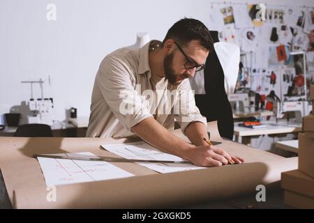 Seamstress works to new clothes ordered by online order Stock Photo