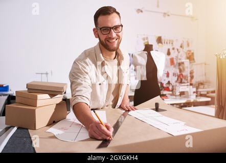 Seamstress works to new clothes ordered by online order Stock Photo