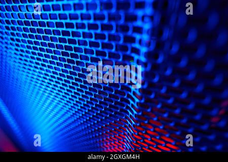 Close up portrait of server metal panel in dark room with blue and pink neon lights Stock Photo