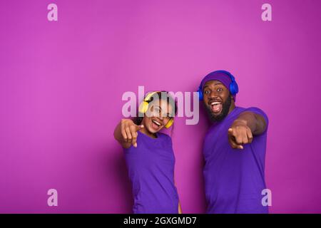 Couple with headset listen to music and have surprised expression. Stock Photo