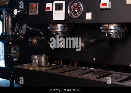 Close-up of Espresso machine making coffee in pub, bar, restaurant. Professional coffee brewing. Coffee Shop Cafeteria Restaurant Service Concept. Stock Photo