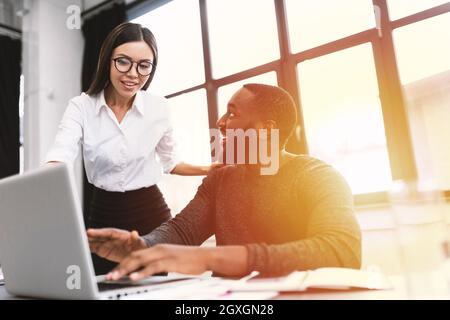 Co-workers in multiethnic company at work on pc Stock Photo