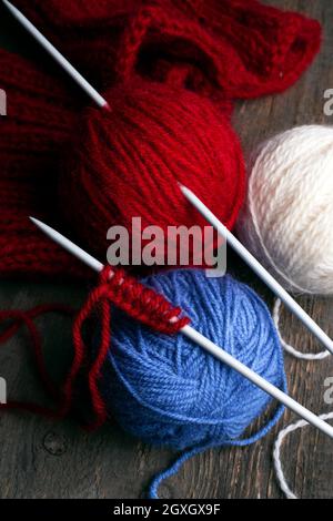 hobby. knitting - set of multicolored balls threads and knitting needles on a wooden table Stock Photo