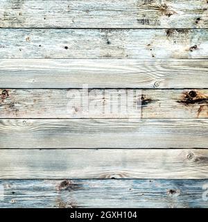 Texture of the planks of an old wooden table in antiqued light pastel colors. Vintage rustic wooden background. Carpentry. Stock Photo