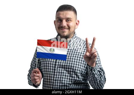 White guy holding a flag of Paraguay and shows two fingers isolated on a white background. Stock Photo