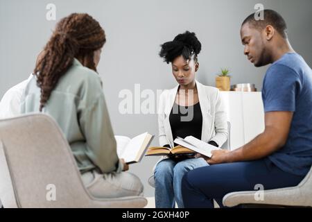 African Group Of People Reading Religious Book Together Stock Photo