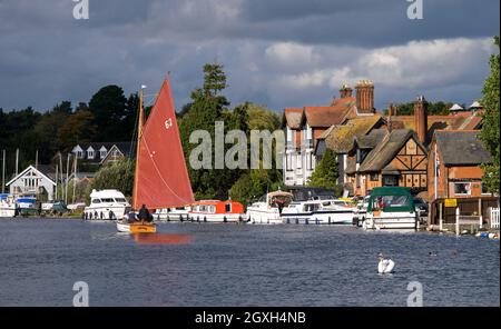 Sailing on Norfolk Broads pasting the Picturesque Village of Horning on The River Bure, Horning, Norfolk, England, UK Stock Photo