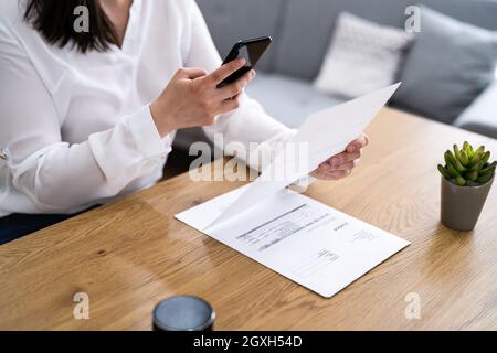 Taking Invoice Document Photo Using Phone Or Smartphone Stock Photo