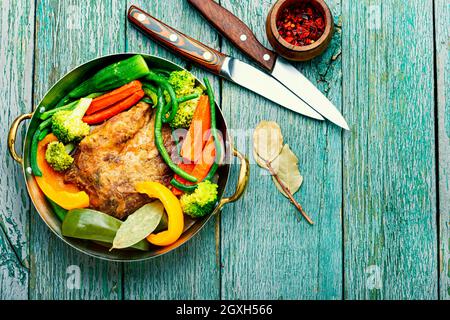 Appetizing beef stew with seasonal vegetables.Sliced pieces of baked beef laid and vegetables Stock Photo