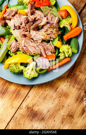 Appetizing beef stew with seasonal vegetables.Sliced pieces of baked beef laid and vegetables Stock Photo