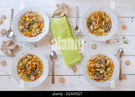 Elegant table setting with full serving of traditional fanesca soup and  accessories Stock Photo - Alamy