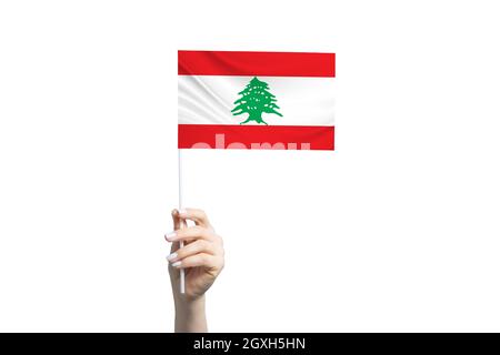 Beautiful female hand holding Lebanon flag, isolated on white background. Stock Photo