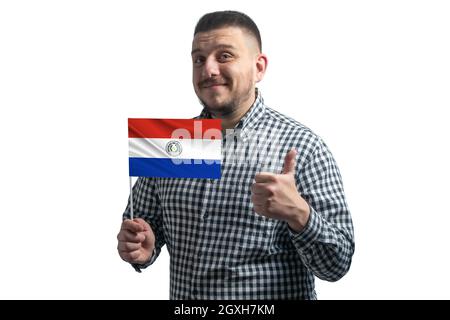 White guy holding a flag of Paraguay and shows the class by hand isolated on a white background. Like for Paraguay. Stock Photo