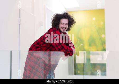 portrait of young man in bathrobe enjoying free time at home Stock Photo
