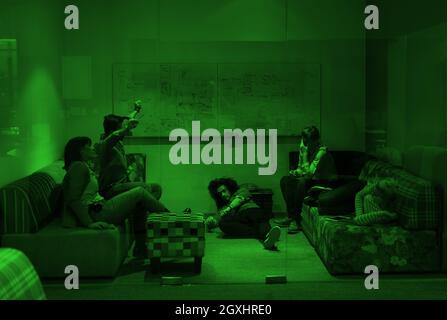 group of young casual software developer sleeping on  sofa during a work break in creative startup office Stock Photo