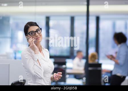 female manager using cell telephone in startup office interior Stock Photo