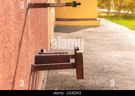 Water hydrant on the wall of residential house. Safety, emergency, supply and industry concept Stock Photo