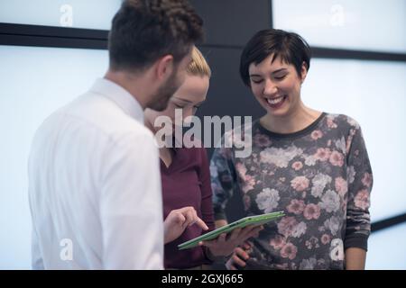young startup business people group, brainstorming and working on tablet computer Stock Photo