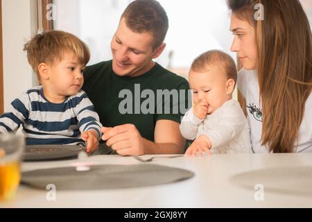 Happy and joyful family is having a great time while sitting all together Stock Photo