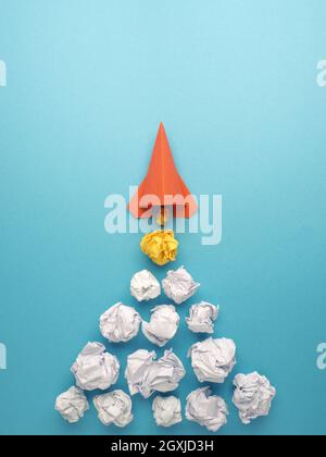 Launching paper rocket with jet stream of paper balls, creativity concept or new ideas metaphor, start up business , new years resolution Stock Photo