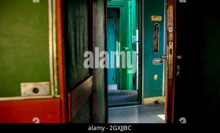 Old steam train car with long wooden corridor Stock Photo