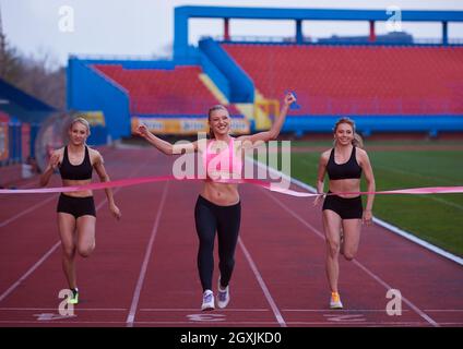 Female Runners Finishing athletic  Race Together Stock Photo