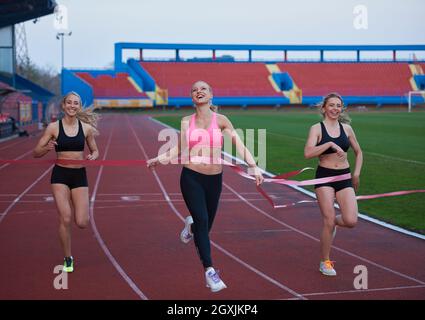 Female Runners Finishing athletic  Race Together Stock Photo