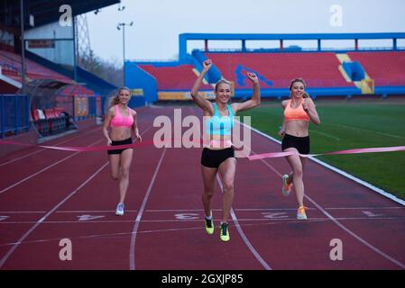 Female Runners Finishing athletic  Race Together Stock Photo