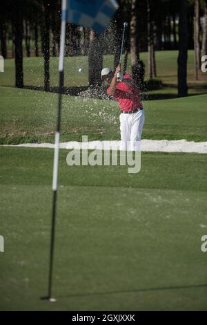 golf player shot ball from sand bunker at course Stock Photo