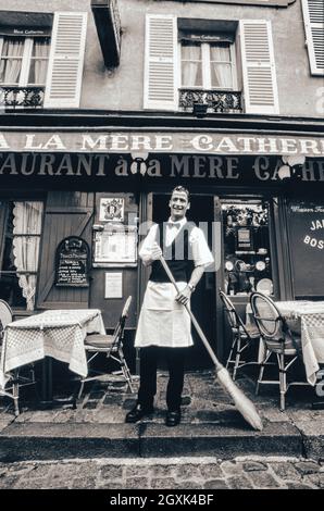 PARIS WAITER MONTMARTRE B&W RETRO VINTAGE STYLE Classic French waiter, morning preparations at landmark Parisian restaurant 'A La Mere Catherine', Montmartre, Paris France. ( © Ian Shaw Photographer) Stock Photo