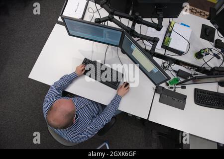 top view of software developer writing programming code on computer Stock Photo