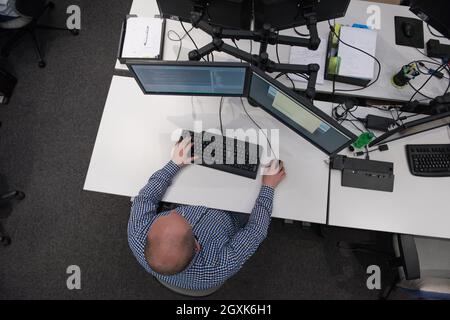 top view of software developer writing programming code on computer Stock Photo