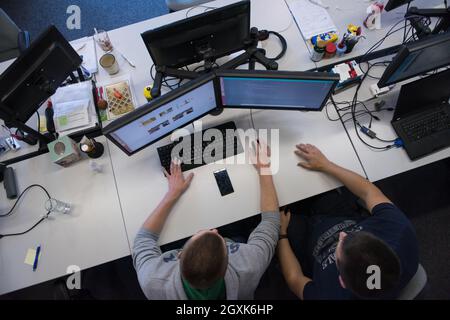 top view of software developers writing programming code on computer Stock Photo
