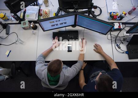 top view of software developers writing programming code on computer Stock Photo