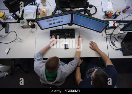 top view of software developers writing programming code on computer Stock Photo