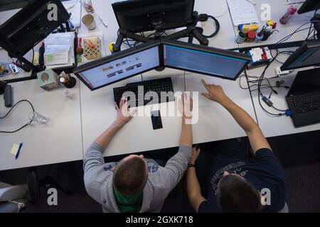top view of software developers writing programming code on computer Stock Photo